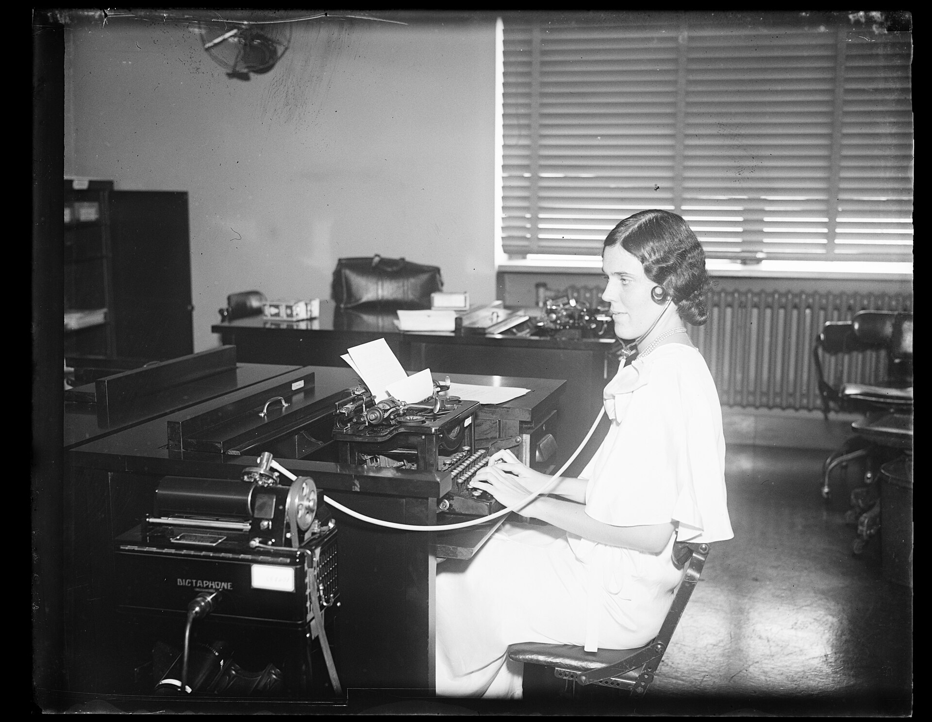 A capability that used to live in a person. Photo: Harris & Ewing, "Woman working at typewriter in office", public domain, via Wikimedia Commons.